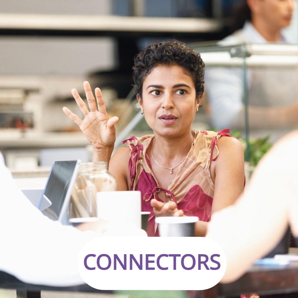 A woman speaking and gesturing during a casual business meeting